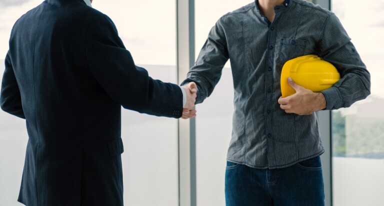 Engineer contractor team handshake after meeting work safety pla